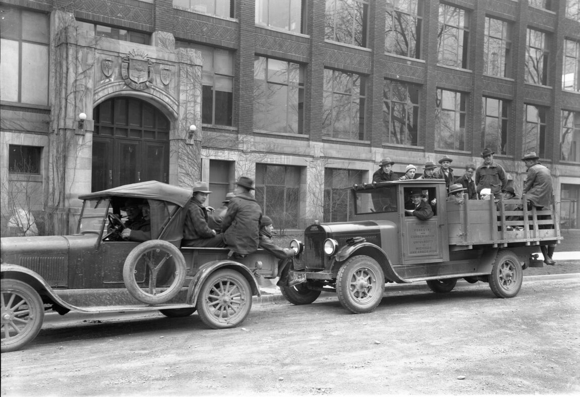 A photo of forestry students gathered in trucks around 1920 at U-M