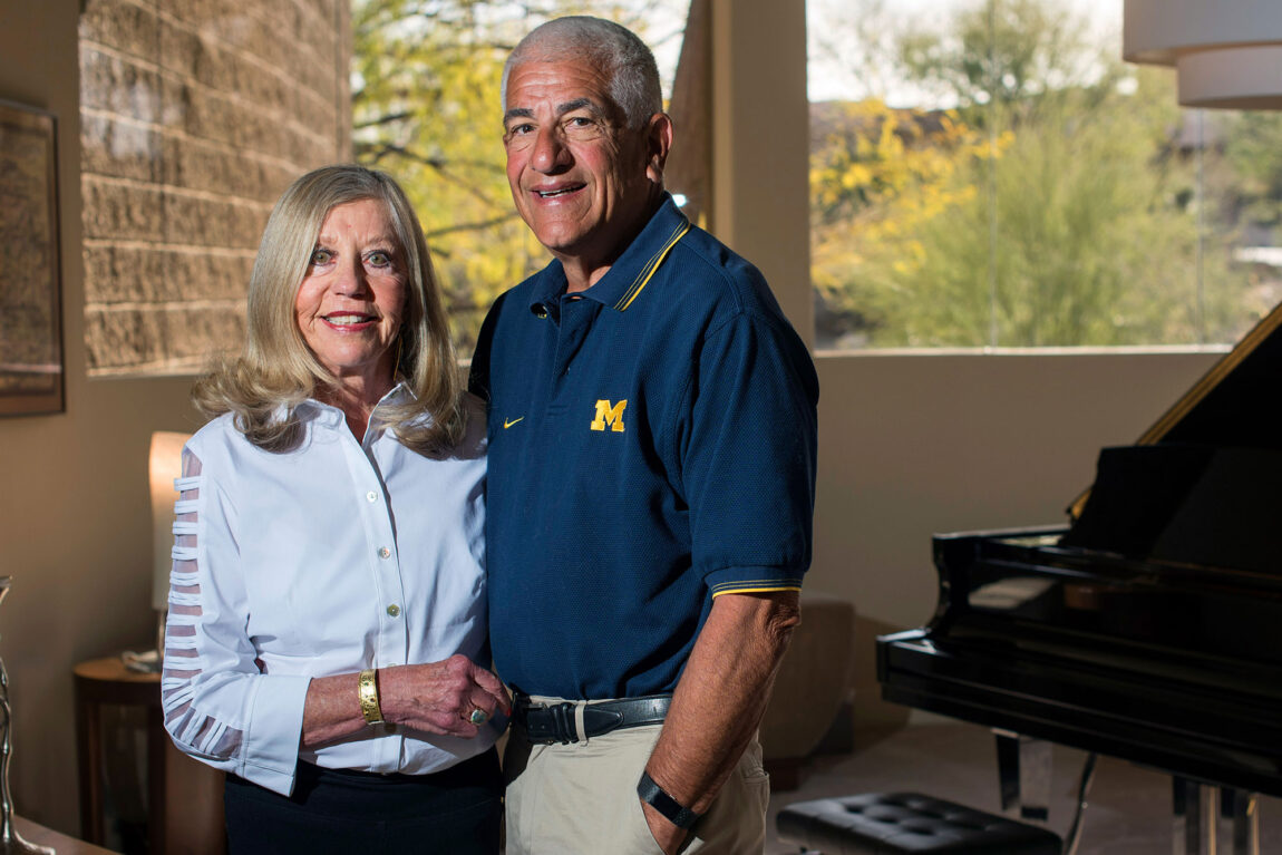 Photo of Susan and Richard Rogel standing in a room with a window and grand piano behind them