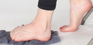 Photo of foot on gray towel with clenched toes