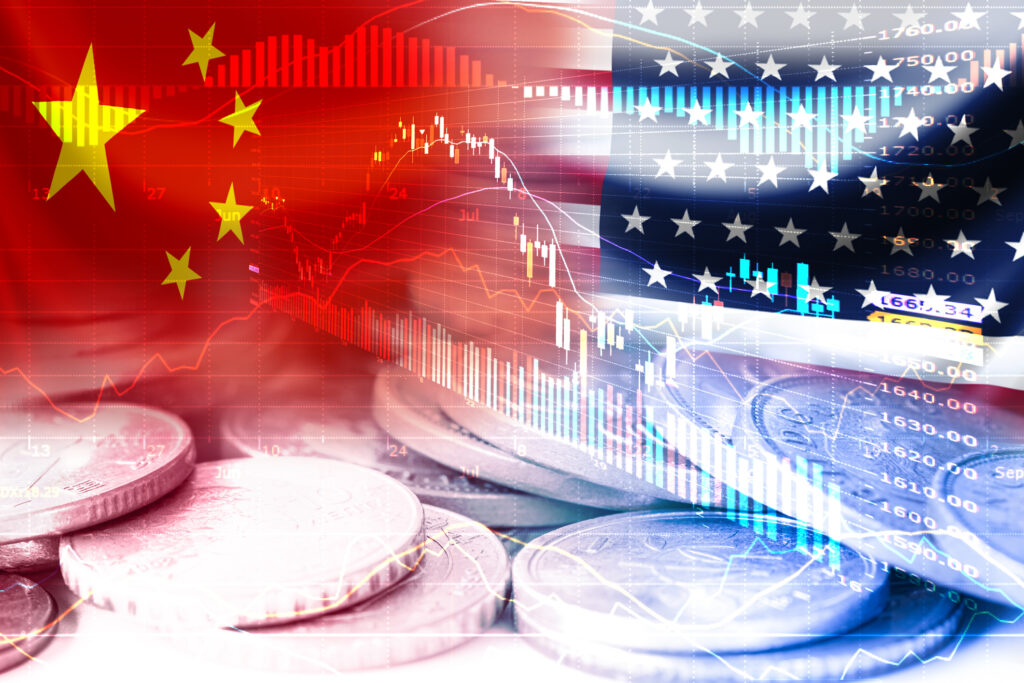USA and China flag on coins and stock market chart, symbolizing economic tariffs trade war and tax barrier between United States of America and China. Image credit: iStock