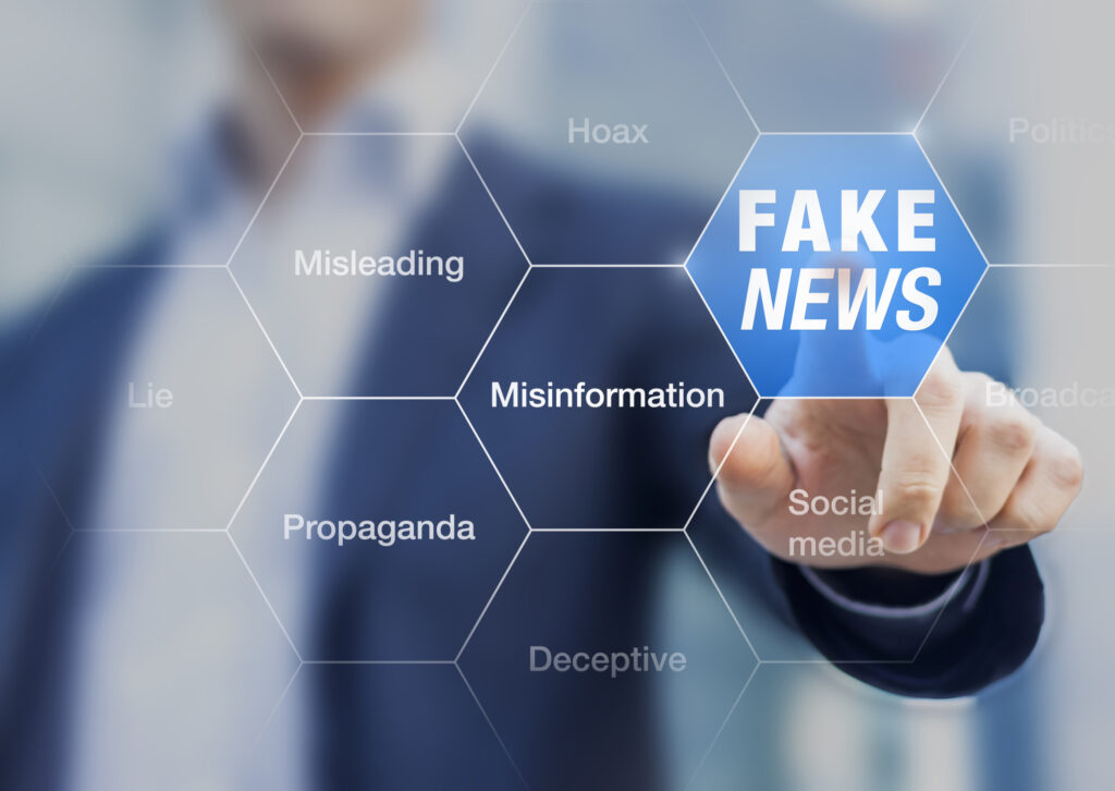 Fake News concept with a person showing misleading, deceptive stories, propaganda, lies, fabricated facts to control or manipulate opinion on internet and social media, political elections. Image credit: iStock