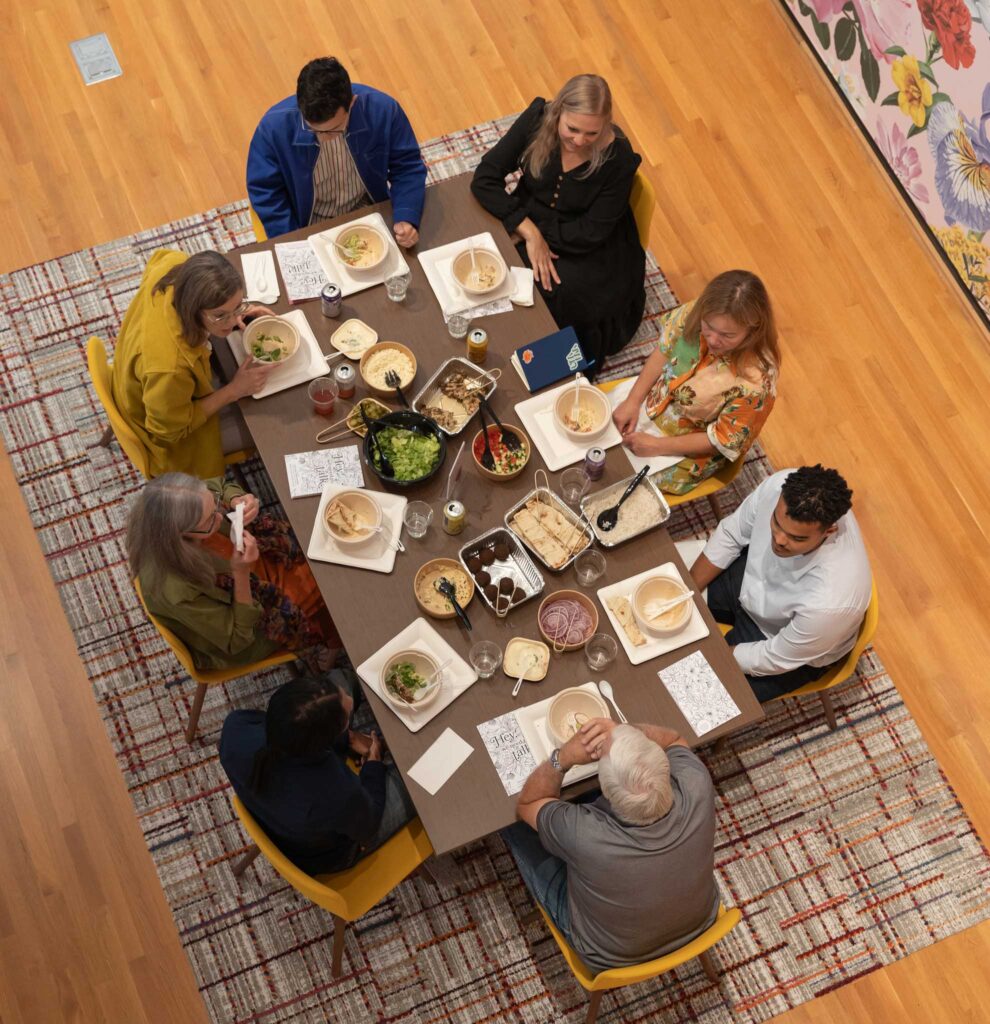 A group gathers for a meal in order to have "art-driven dialogues that aim to repair the social fabric of our country."