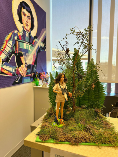 A photo of a diorama of a Barbie and monkeys