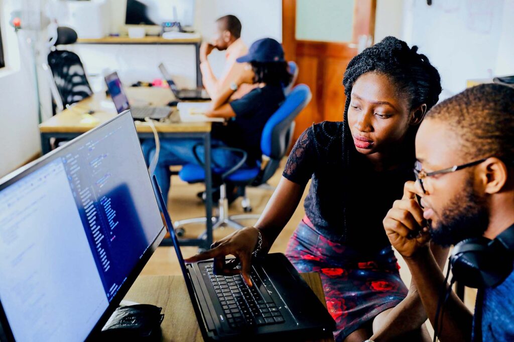 Two students working at a computer. Image credit: Desola Lanre-Ologun
