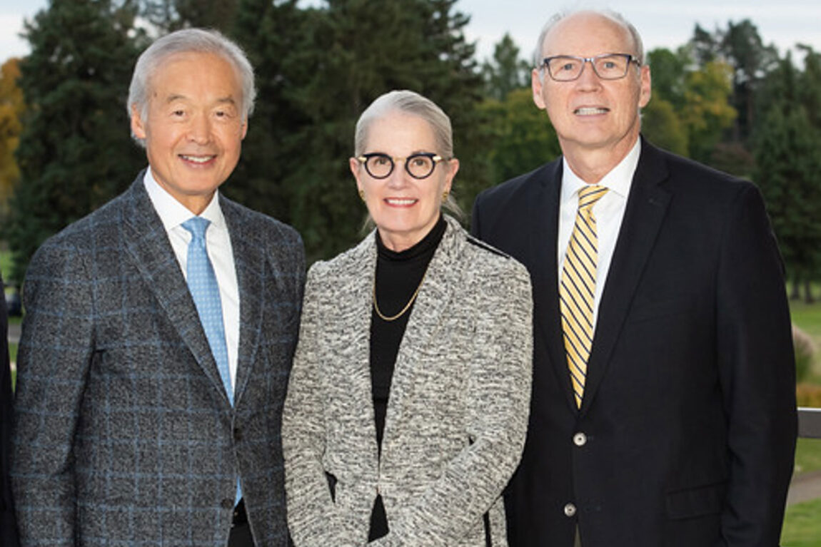 Photo of two men and a woman.