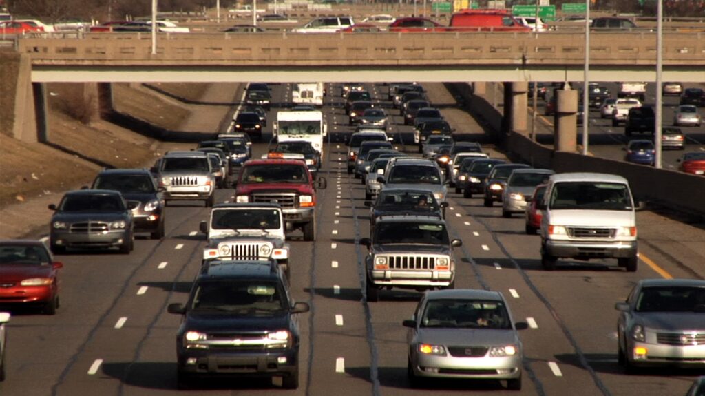 Four lanes of heavy traffic move toward the camera.