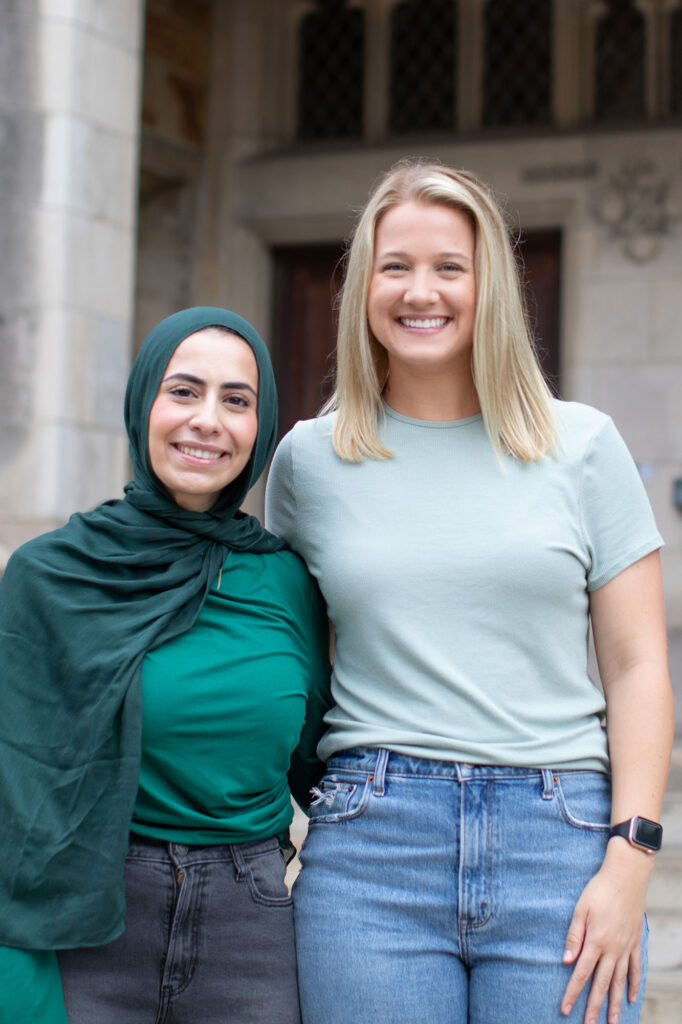 Photo of two women smiling and looking froward.