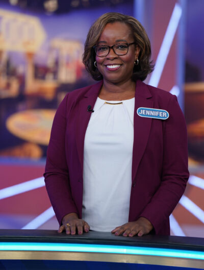 A photo of a woman smiling on the set of "Wheel of Fortune"