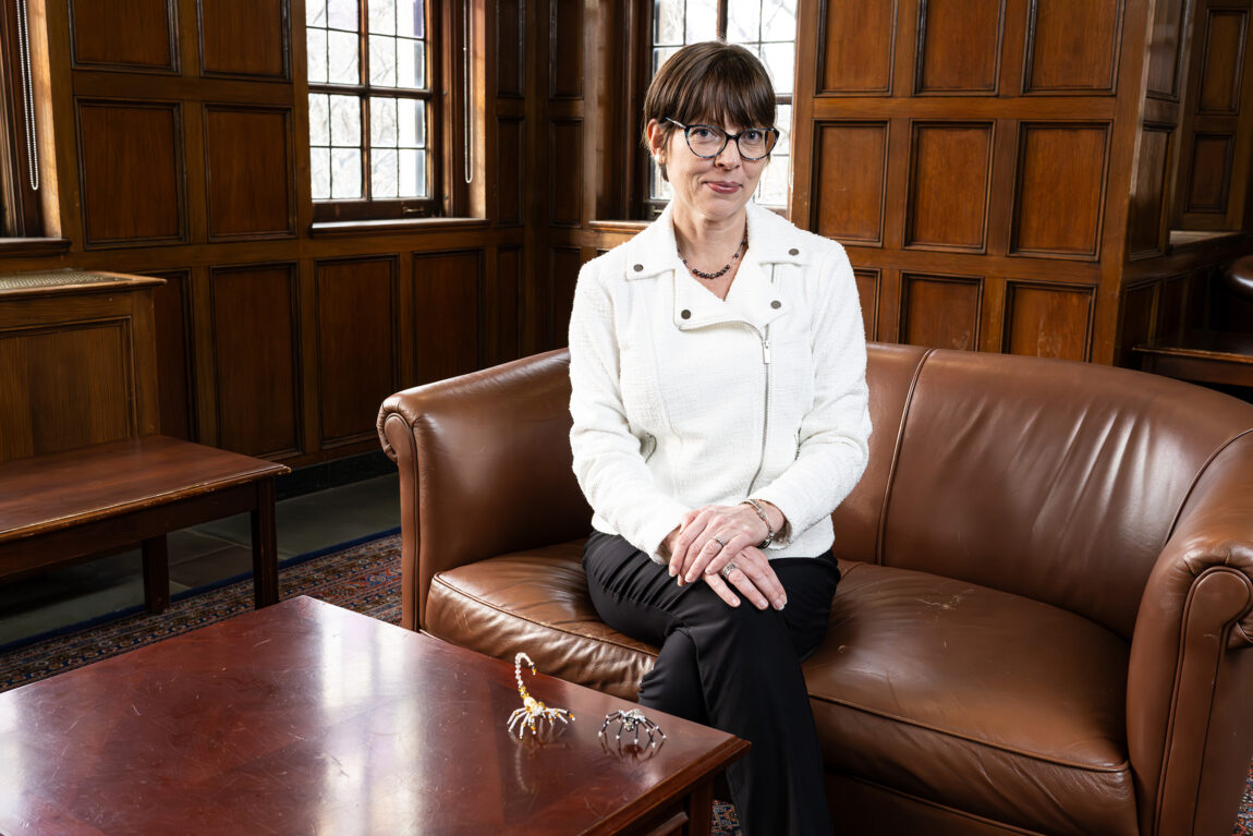 A photo of a woman sitting on a brown couch