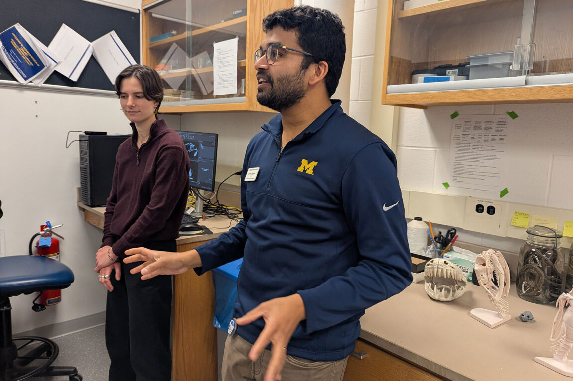 Photo of a woman and a man in a lab, discussing their work.