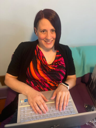 A woman sitting at a laptop