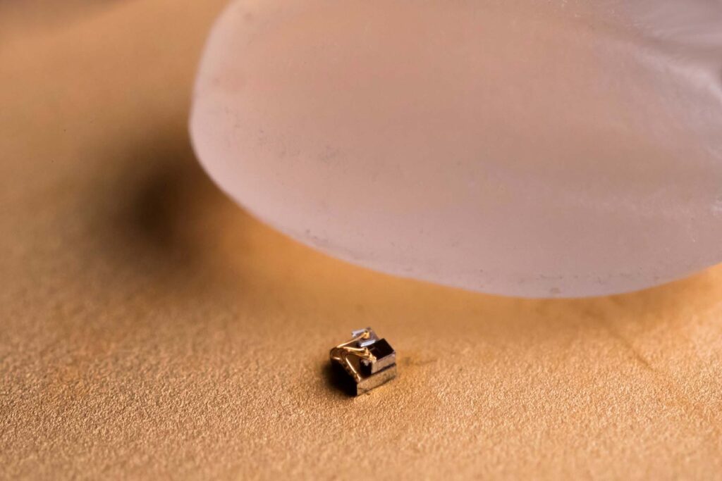The Michigan Micro Mote (M3) computer next to a grain of rice for scale. Image credit: Joseph Xu, Michigan Engineering