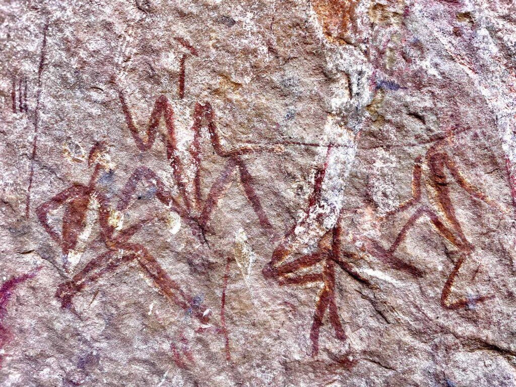 Painted human figures on the wall of Ha Soloja Rock-shelter, highland Lesotho, adopting postures similar to those of Kalahari shamans entering trance.