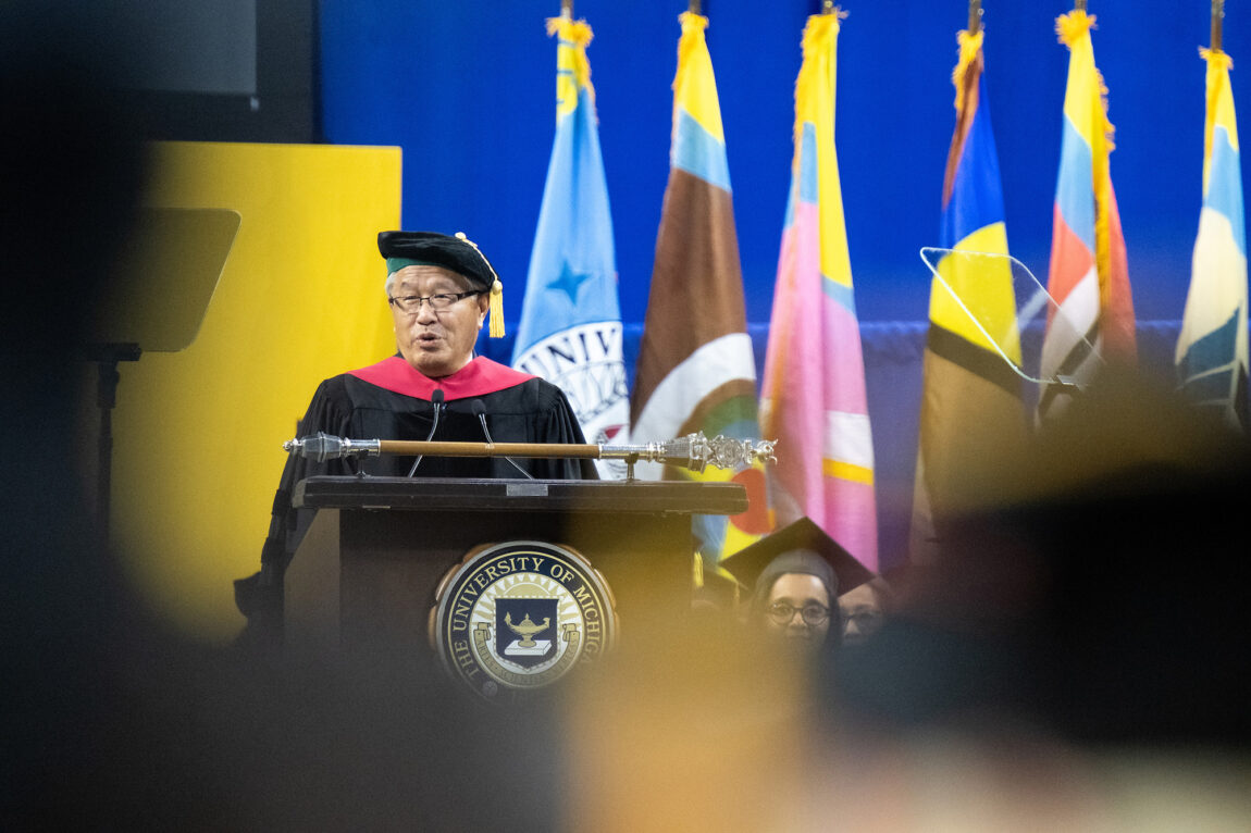 A man standing at a lectern addressing a crowd