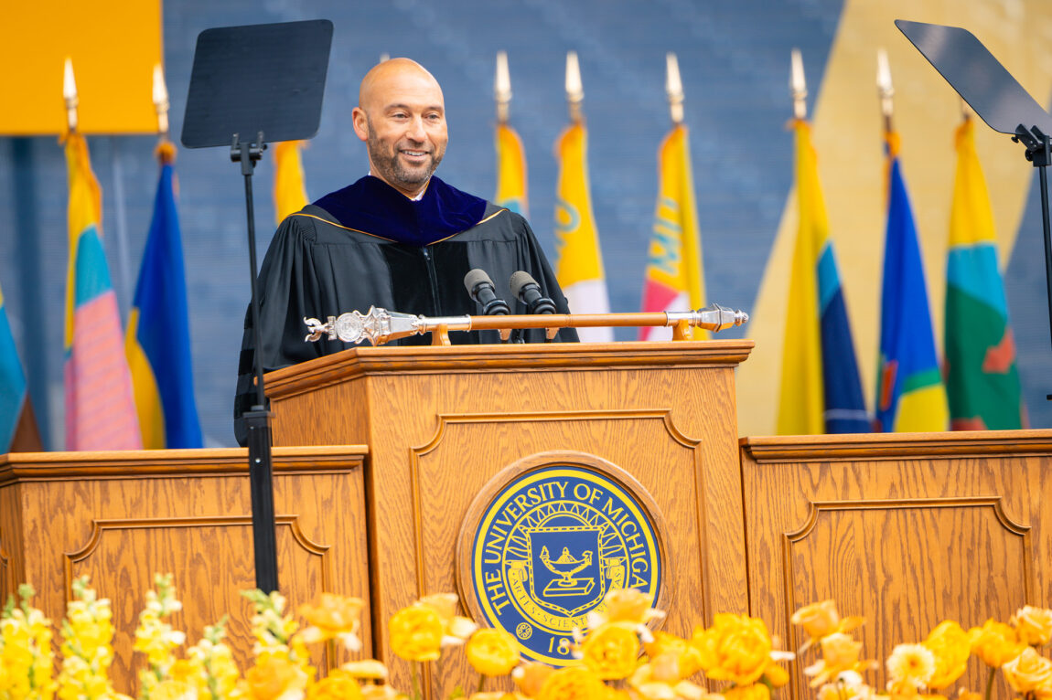 A man standing at a lectern addressing a crowd