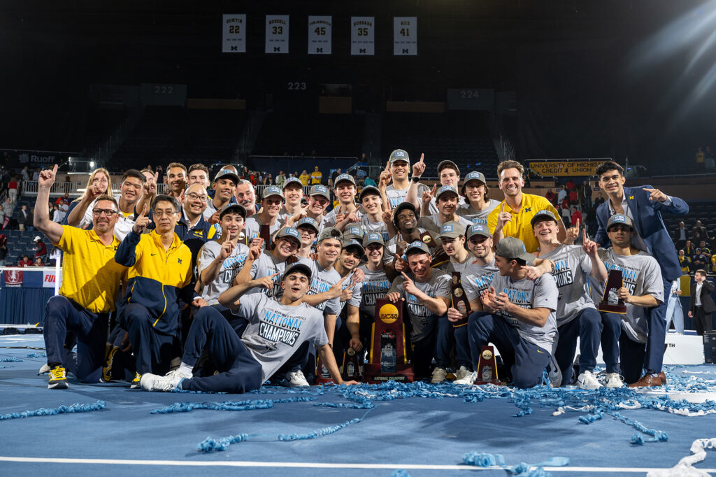 The 2025 University of Michigan men's gymnastics team celebrating after winning the NCAA championship