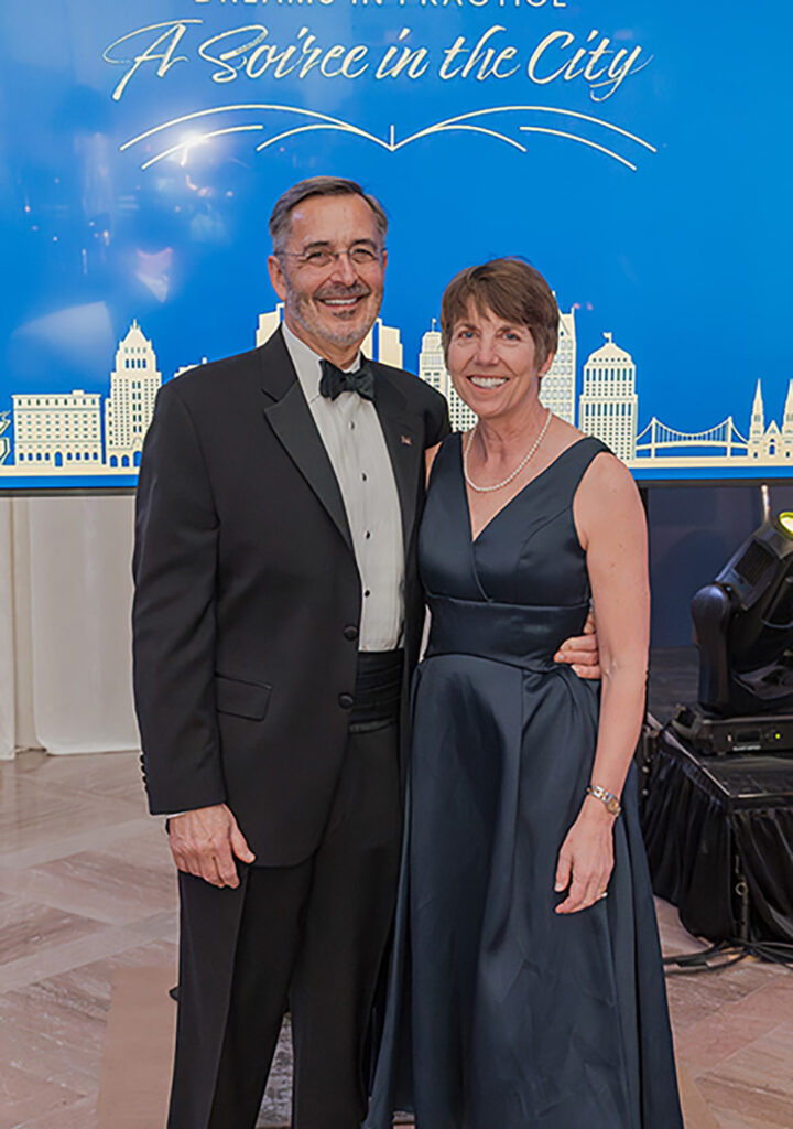 A man and a woman standing side by side wearing formal clothes