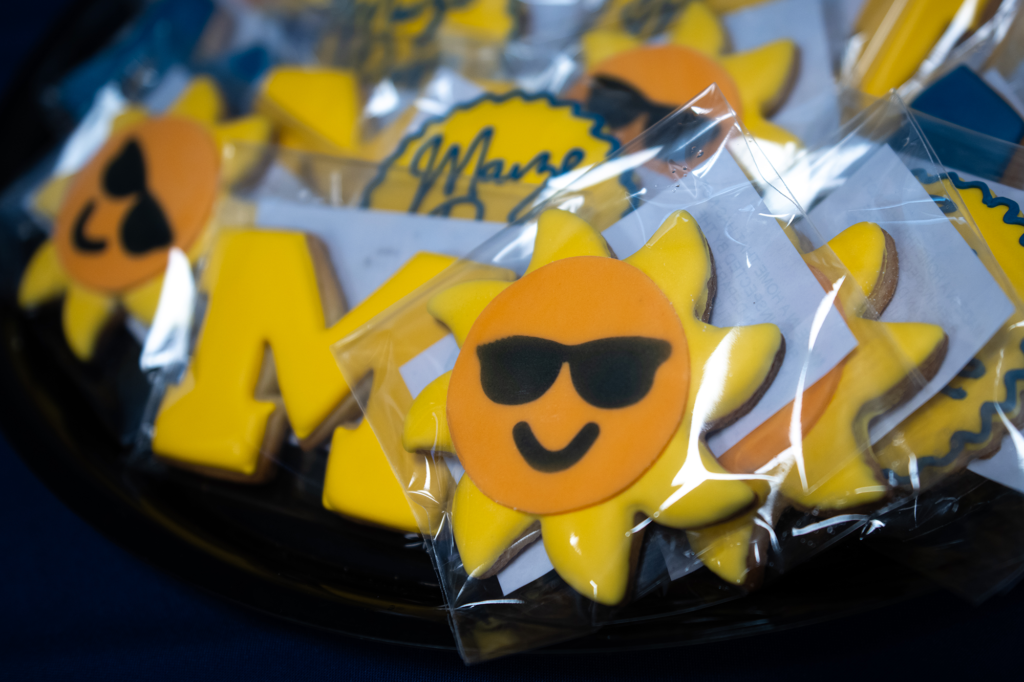 Packages of yellow block M and flowers that are cookies