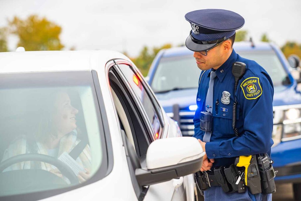 A Michigan State Police officer chats with a citizen during a traffic stop. Image credit: Michigan State Police
