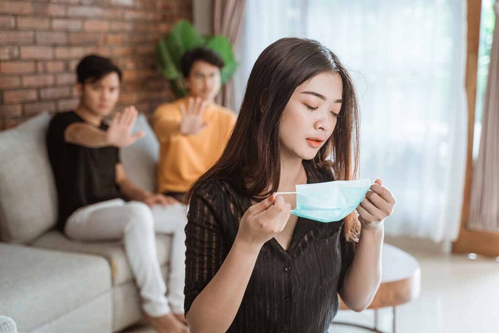 People separating and asking another person to don a mask to avoid contagions. Image credit: Adobe Stock