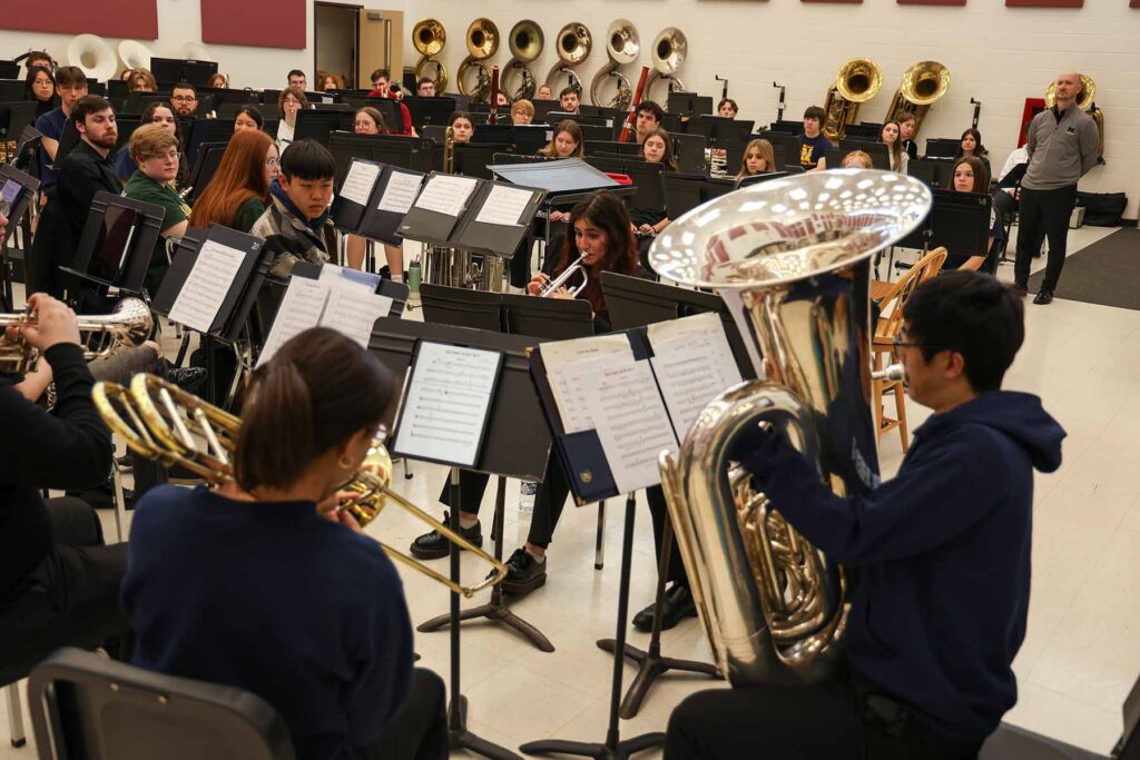 U-M Symphony Band members play "The Pride of the Wolverines," a march by John Philip Sousa, during a clinic with high school students in Midland.