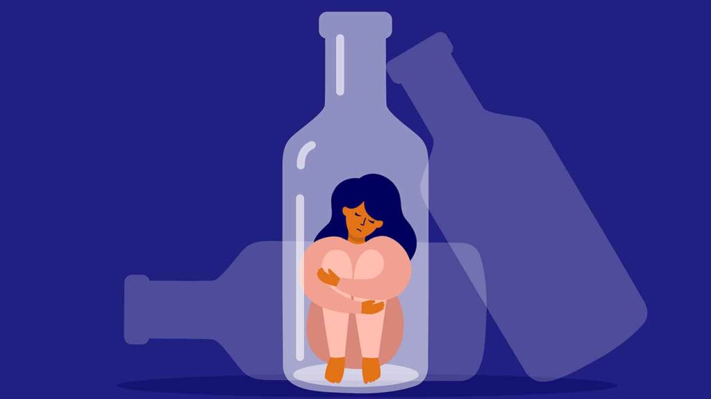 Female alcoholism concept. Unhappy woman sitting at bottle bottom hugging her knees. Image credit: Adobe Stock