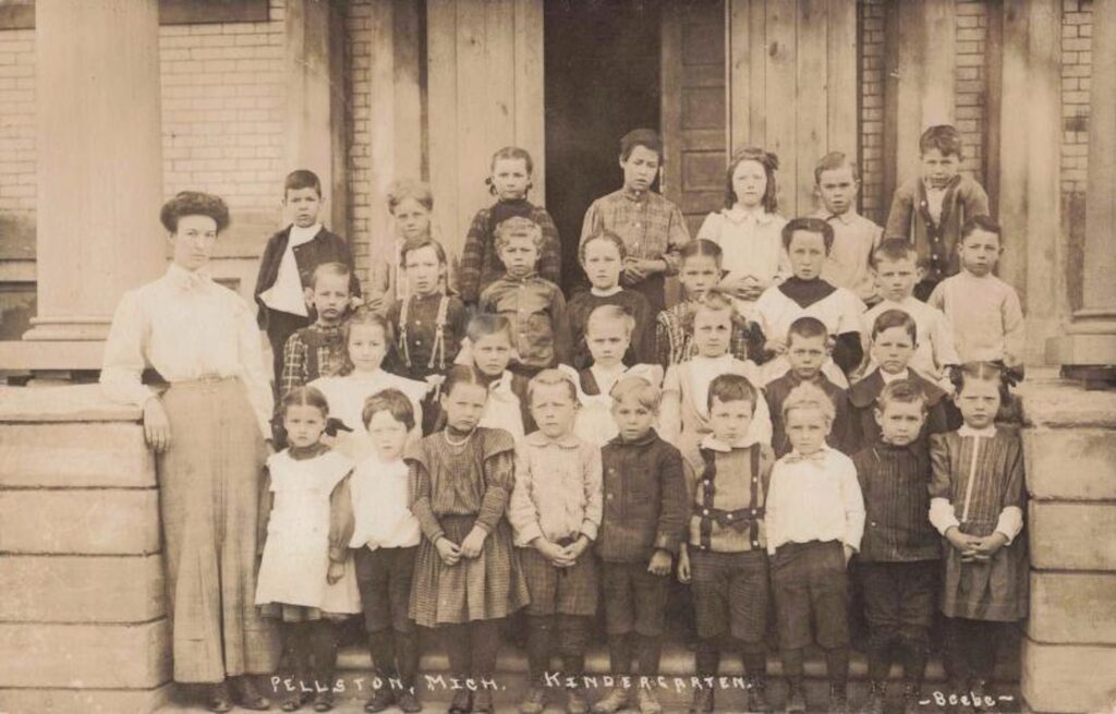 Pellston, Michigan kindergarten students and their teacher pose for a picture. Image credit: David V. Tinder Collection of Michigan Photography, University of Michigan William L. Clements Library.