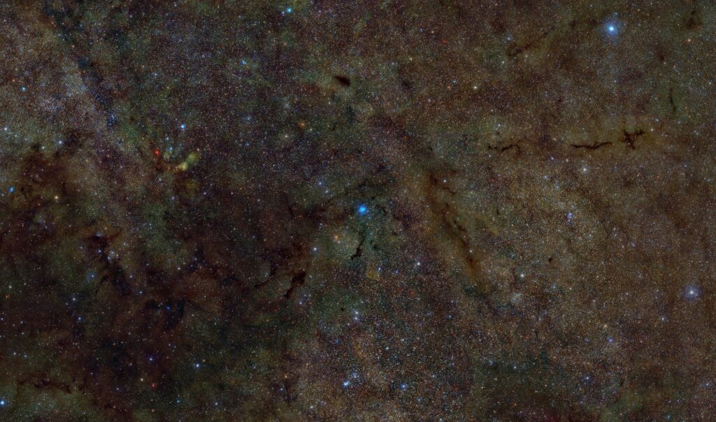 Optical, infrared, and X-ray composite image of a portion of the interstellar gas and dust with an X-ray source at the center.