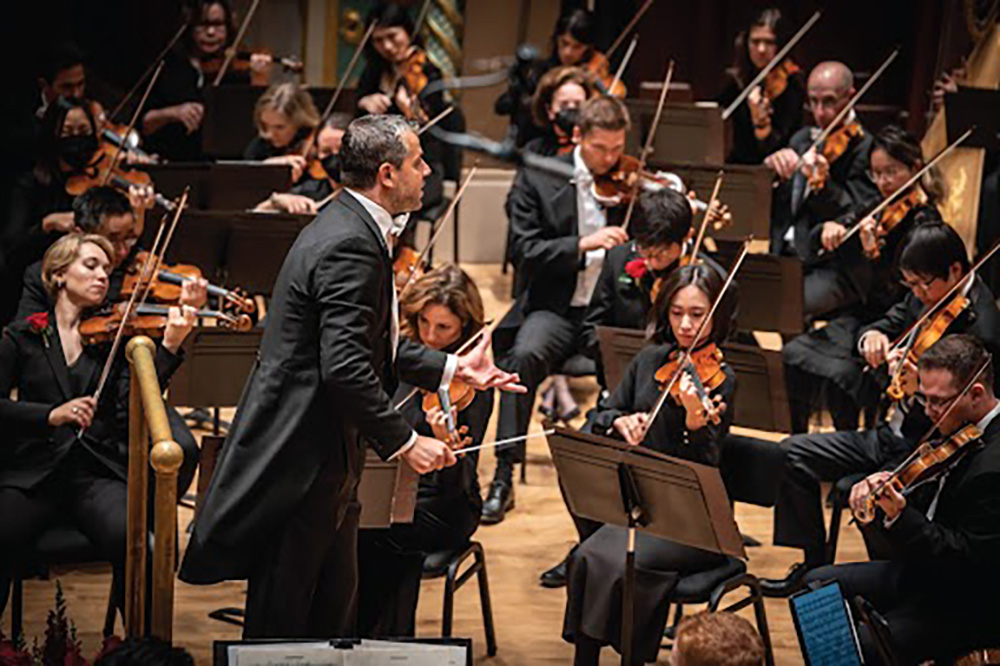 A band conductor directs an orchestra
