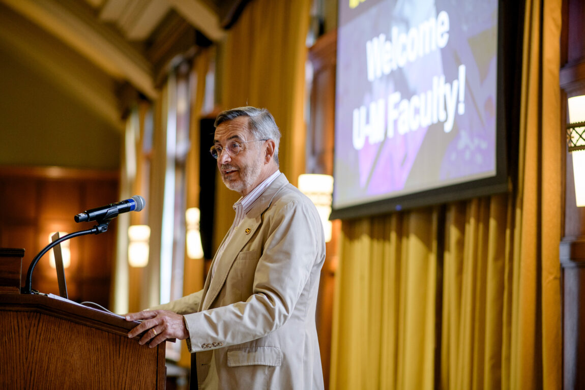 A man stands at a lectern and delivers a speech