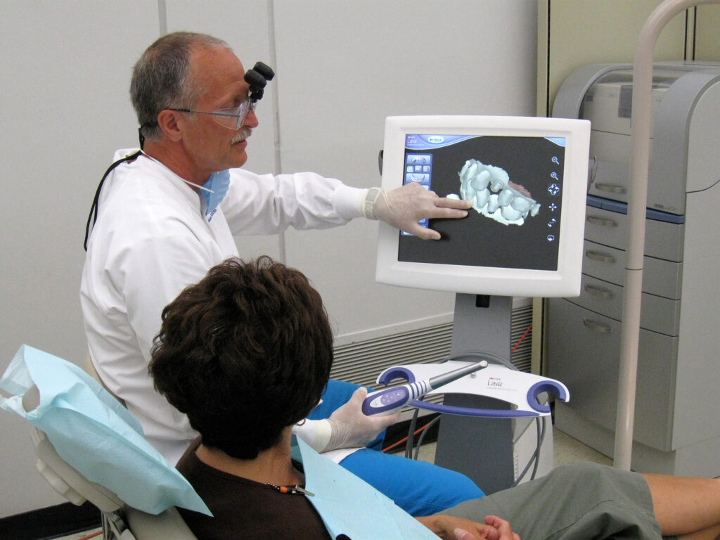A dentist works on a computer