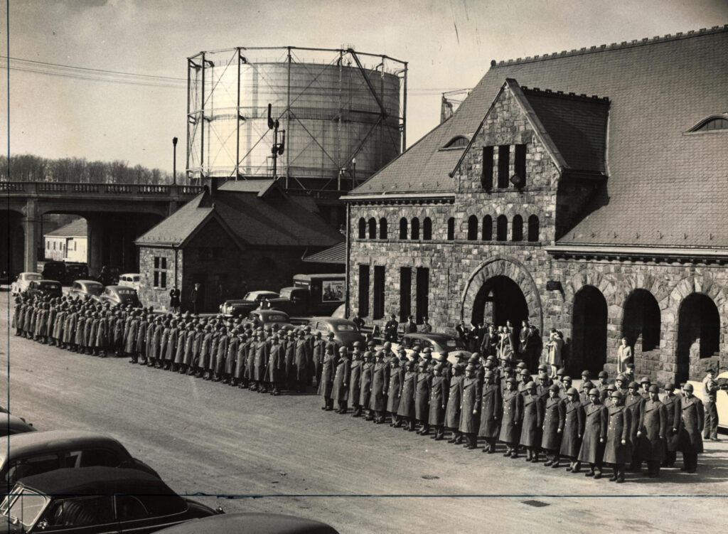 Army units stand at attention outside the Ann Arbor train station, circa 1941-44.