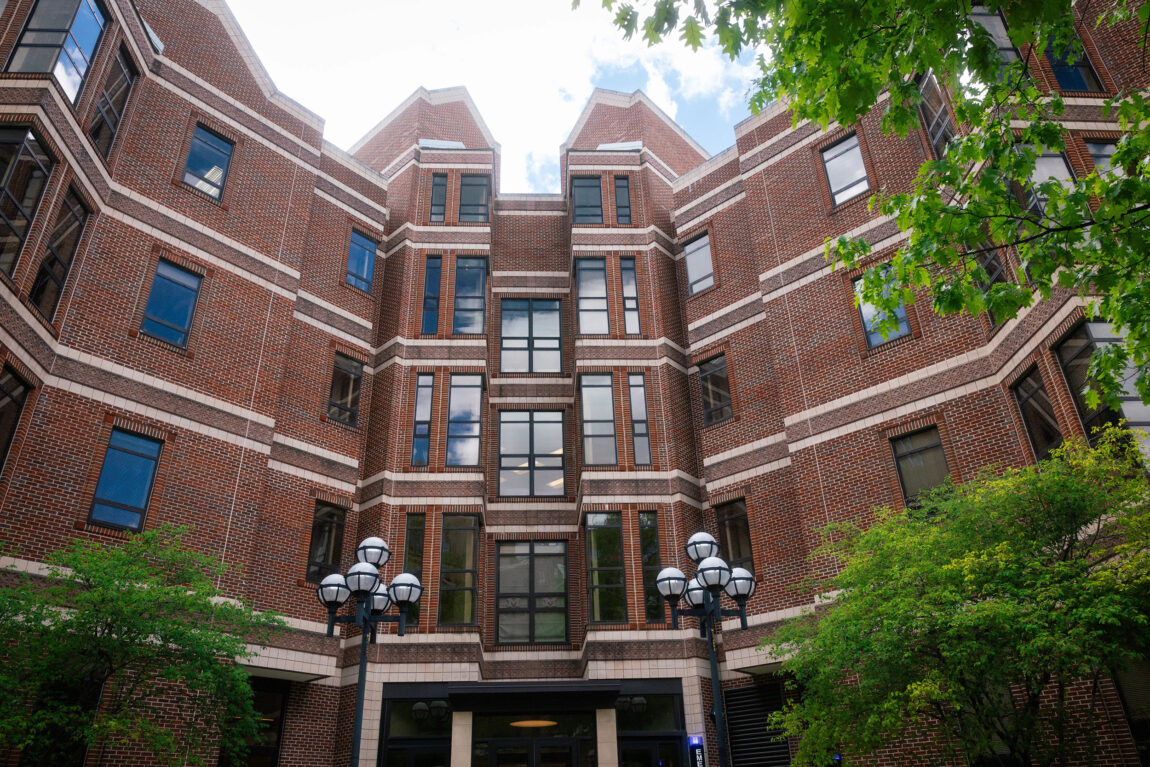 A brick building with a partly cloudy sky