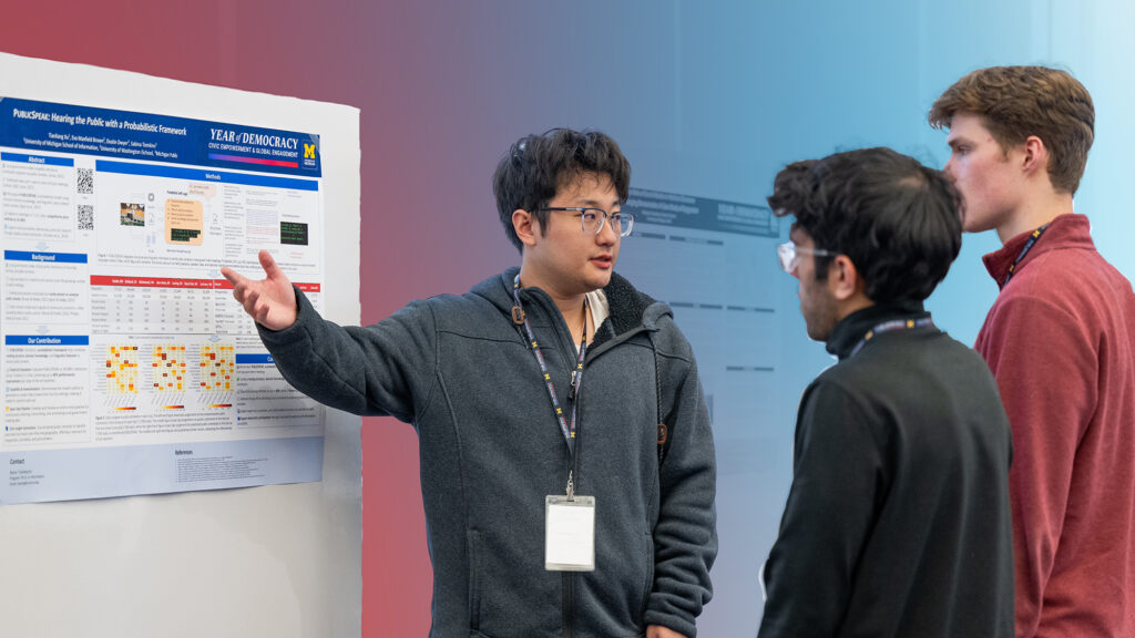 Students listening to a poster session.