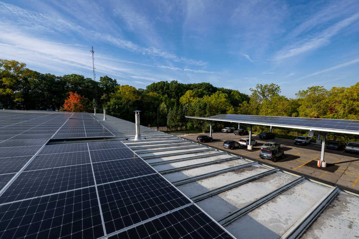 Solar panels on the roof of a building and on a carport
