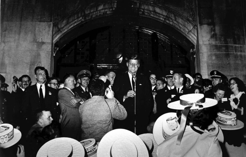 John F. Kennedy standing on the steps outside the Michigan Union