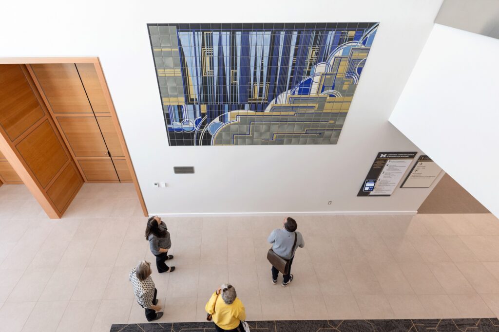 Waterfall Abstraction, a new mural designed by Nawal Motawi, hangs in the lobby of the Leinweber Computer Science & Information Building. 
