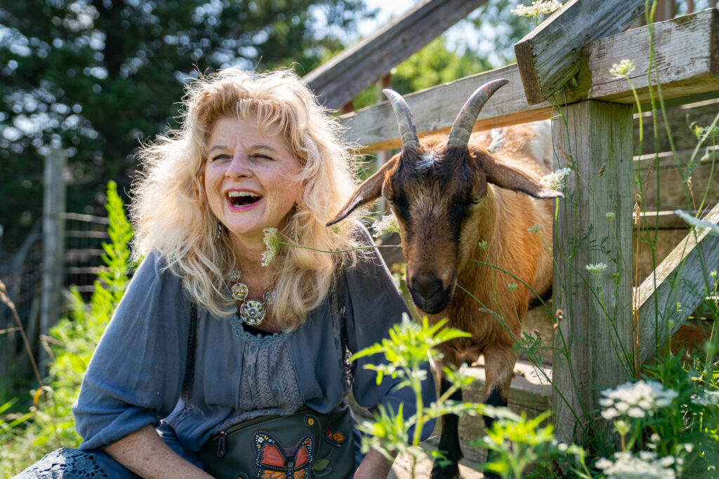 Sanders with Jalapeño Pepper, one of three horned goats who engage in animal-assisted therapy at Lovingway Farm.
