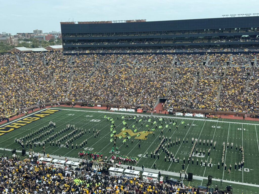 The University of Michigan Marching Band, alongside U-M School of Music, Theatre & Dance musical theatre students and percussion studio students perform selections from "Wicked" at halftime of the Sept. 13 football game against Central Michigan University. MMB spells out "Wicked." Image credit: Michigan Marching Band