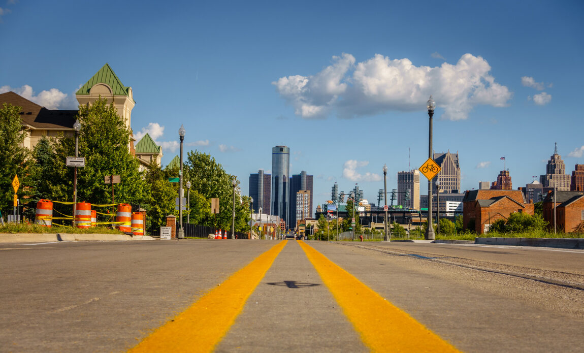 A street-level look at the skyline of downtown Detroit under sunny skies