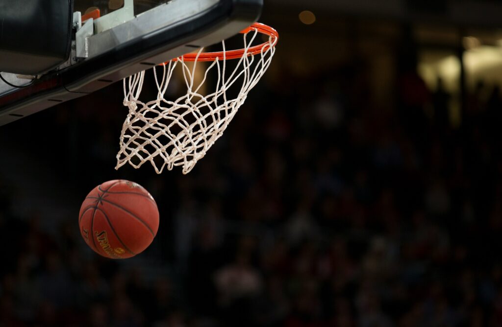 Ball under basketball ring. Image credit: Markus Spiske, Unsplash
