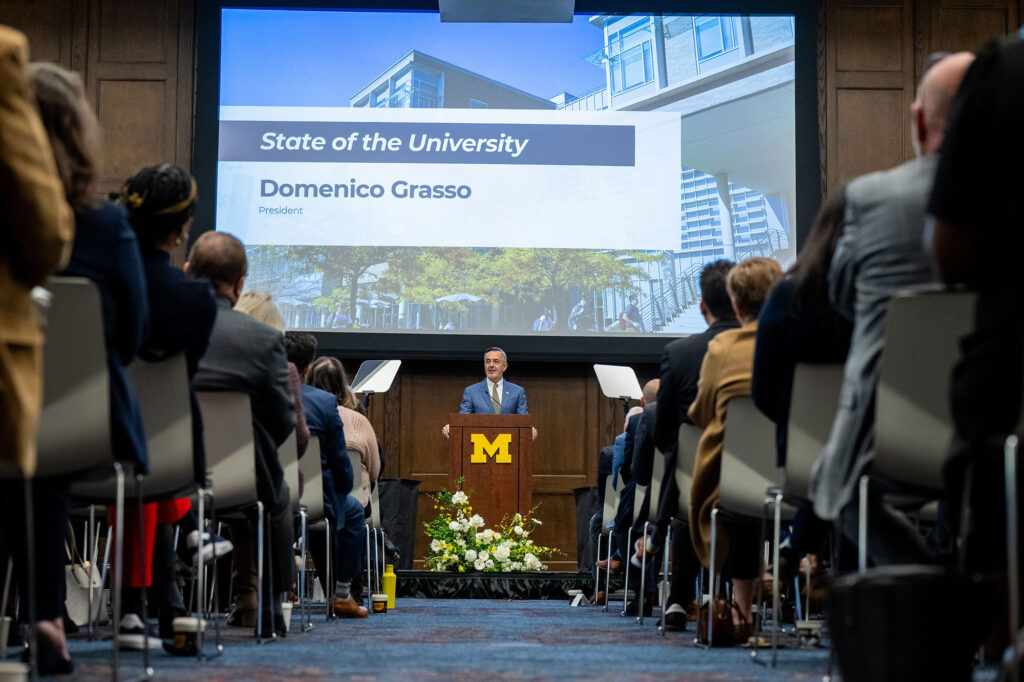 Man addresses room of people