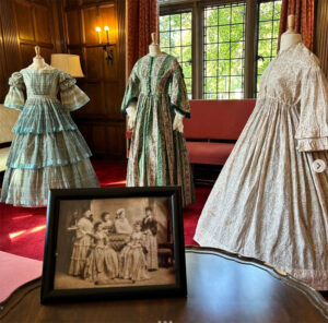 Period dresses worn by Martha Wolford Cook are displayed on mannequins at the Martha Cook Building at U-M.