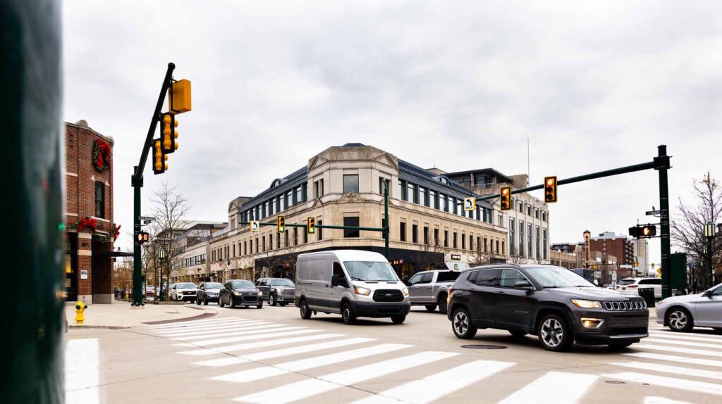 Vehicles are seen passing through a busy downtown intersection.