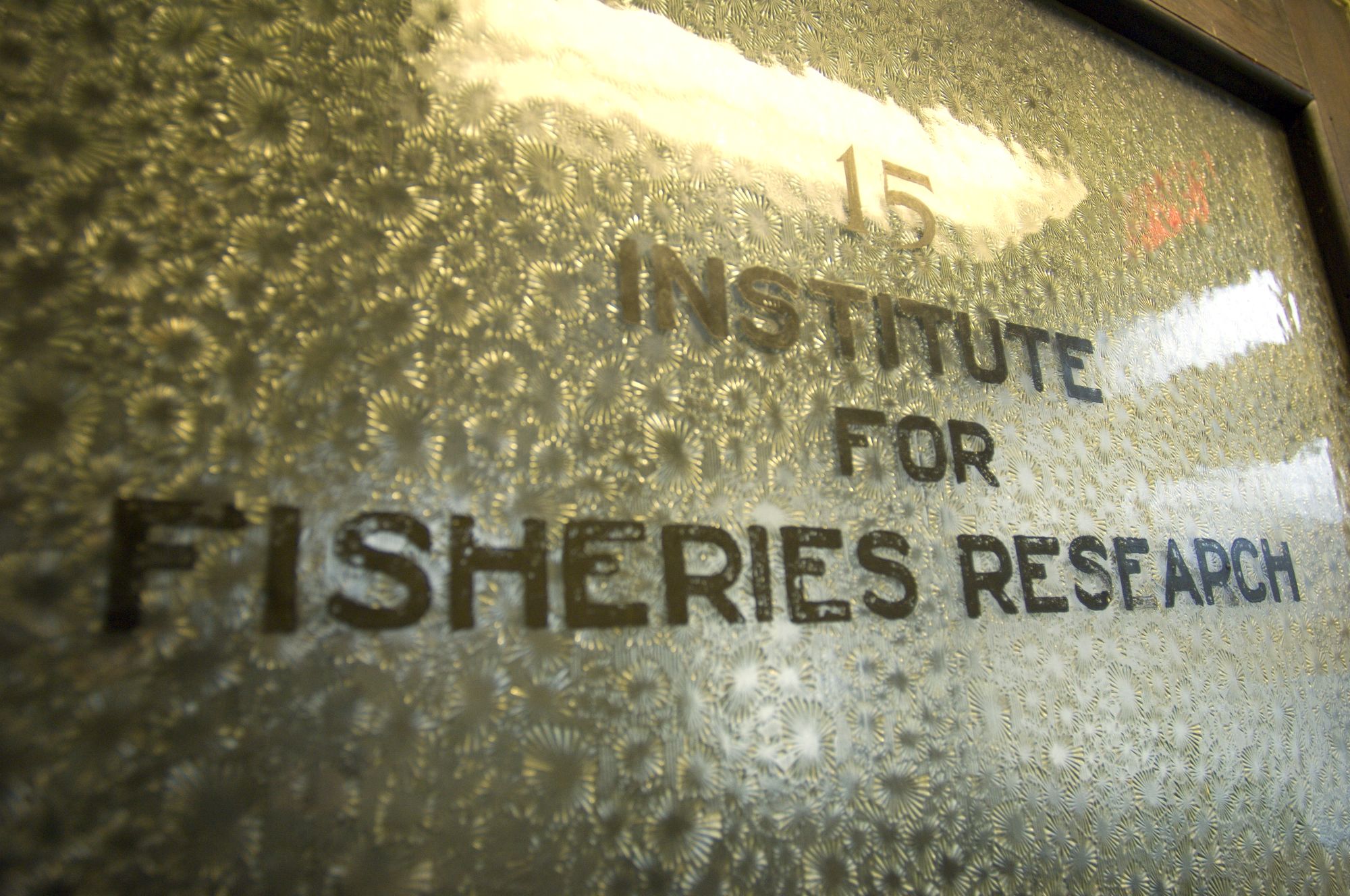 A pain of textured glass in a door frame reads "15, Institute for Fisheries Research."