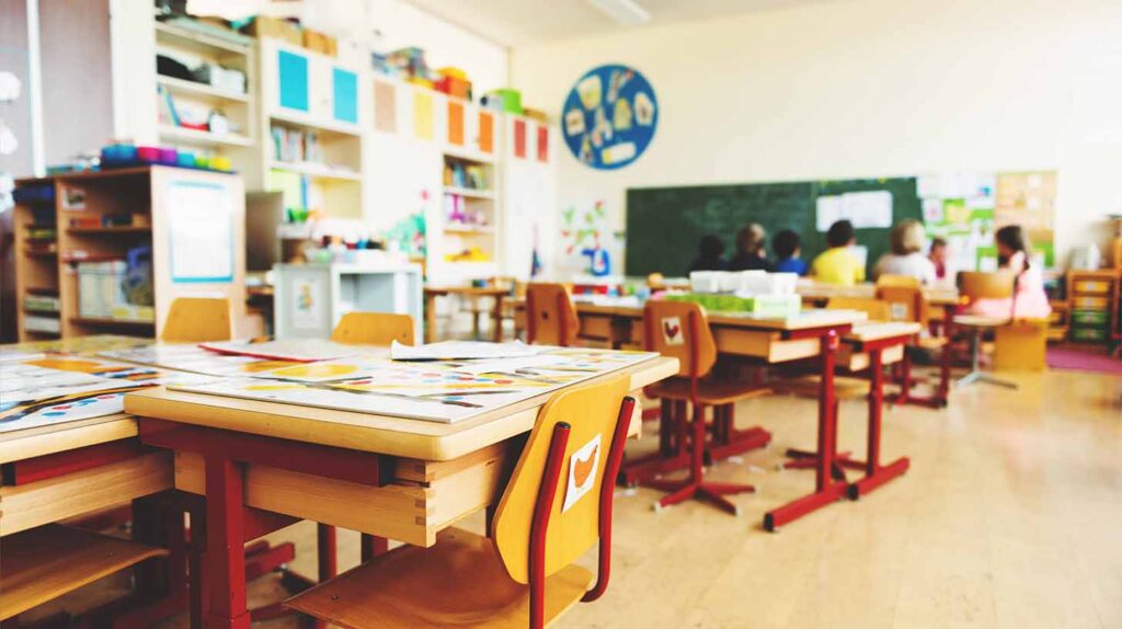 A sparsely populated elementary classroom. Image credit: Adobe Stock
