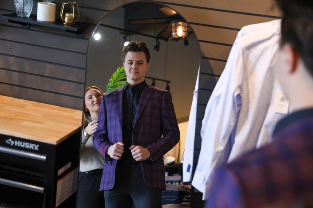 Jessica Bazner assists a customer at Kevin James Menswear. Image credit: Jeremy Marble, University of Michigan News