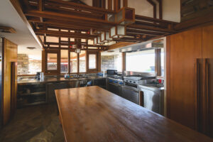 The interior of a Frank Lloyd Wright-inspired home on the outskirts of Ann Arbor, Michigan, which features a restaurant-styled kitchen.