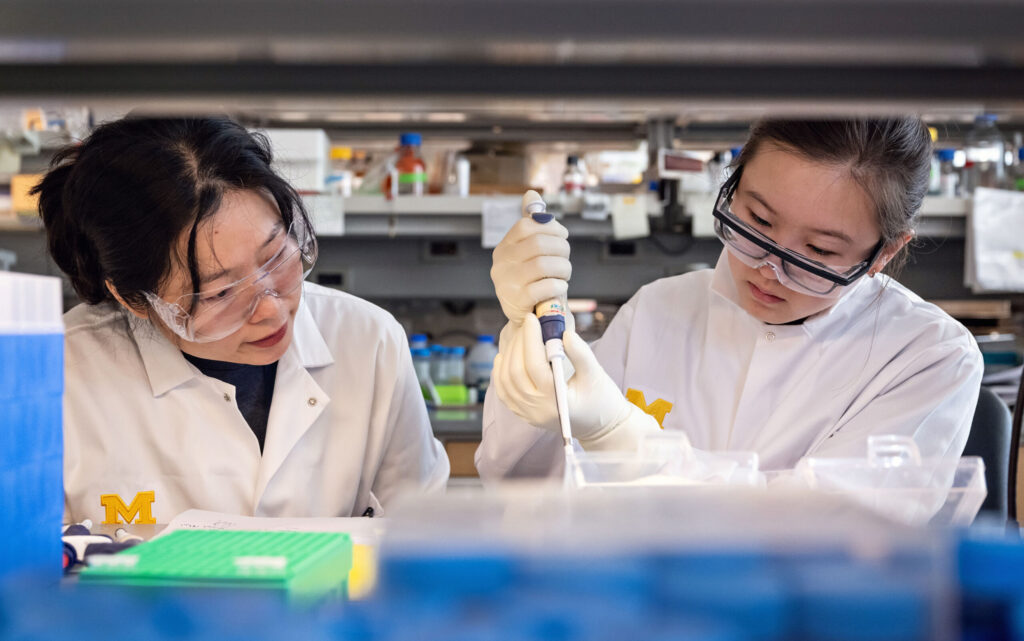 Two students in a lab conducting experiments