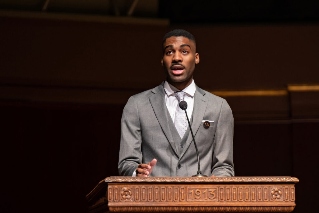A man stands at a podium and speaks